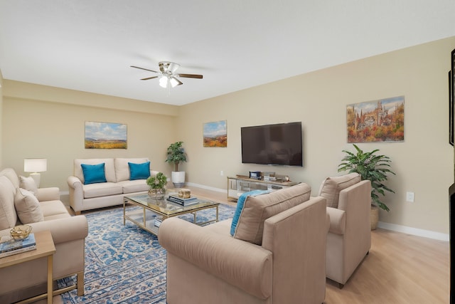 living room featuring ceiling fan and light hardwood / wood-style flooring