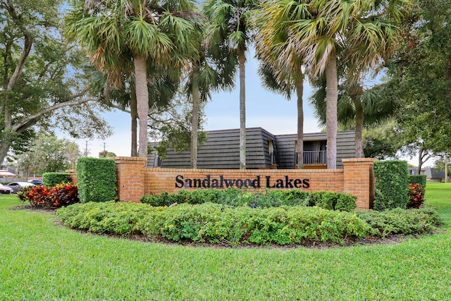 community / neighborhood sign with a lawn