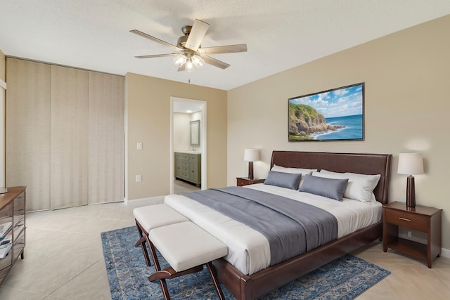 bedroom with ensuite bathroom and ceiling fan