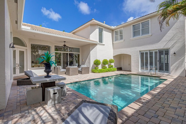 view of pool featuring ceiling fan, a patio, french doors, and an outdoor living space