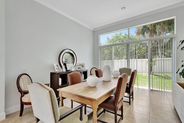 dining room with ornamental molding, a wealth of natural light, and light tile patterned flooring