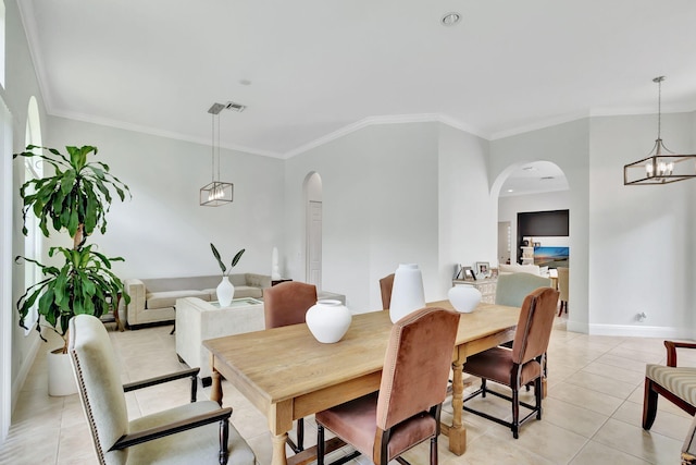 tiled dining area featuring a notable chandelier and crown molding