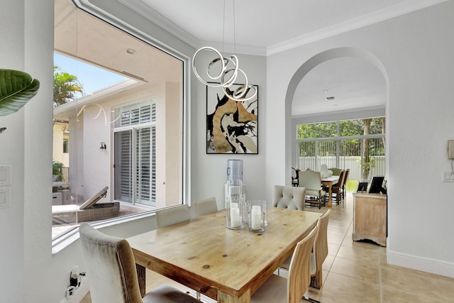 dining room with plenty of natural light, light tile patterned floors, and crown molding