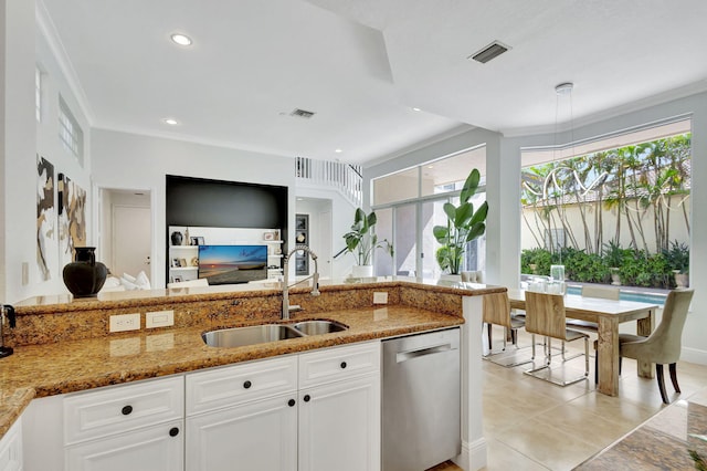 kitchen with stainless steel dishwasher, stone counters, sink, and white cabinetry