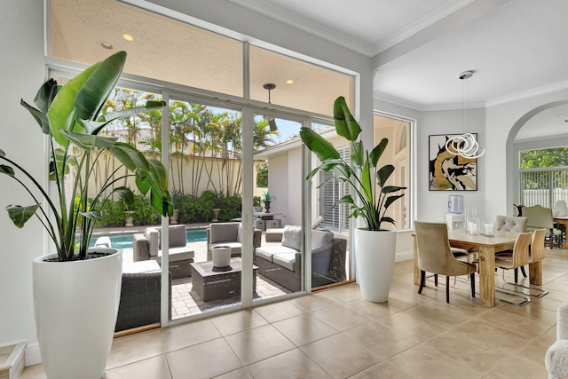 interior space featuring light tile patterned flooring and crown molding