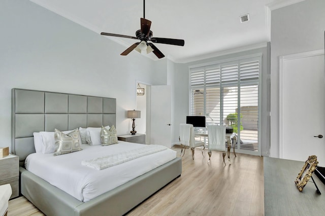 bedroom with ornamental molding, light wood-type flooring, and ceiling fan