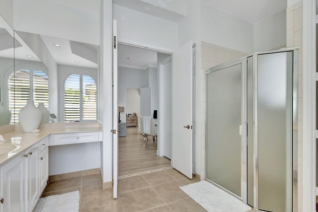 bathroom featuring vanity, tile patterned floors, an enclosed shower, and ornamental molding