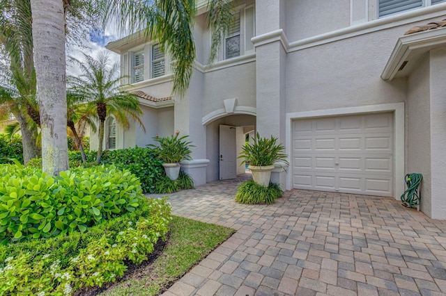 view of exterior entry with a garage