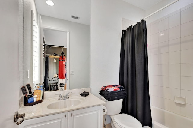 full bathroom featuring vanity, shower / bathtub combination with curtain, and toilet