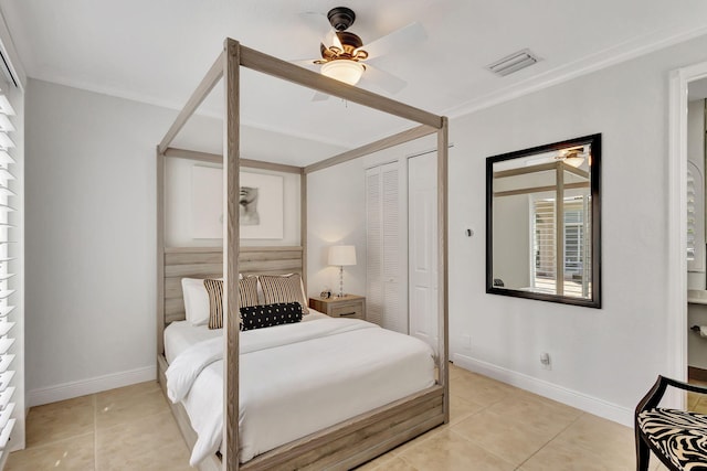 bedroom featuring light tile patterned floors, ceiling fan, and a closet