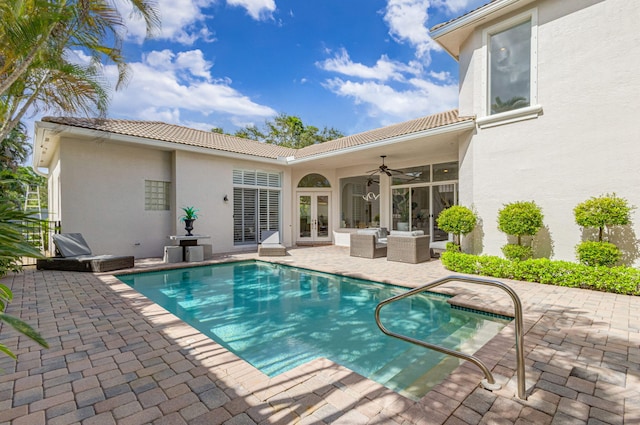 view of swimming pool featuring ceiling fan, a patio, french doors, and an outdoor hangout area