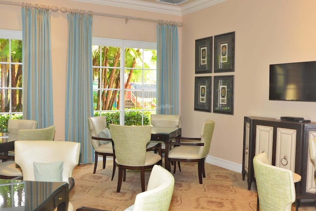 dining space with ornamental molding