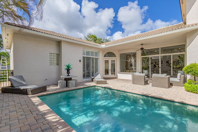 back of property with a patio area, ceiling fan, french doors, and an outdoor living space