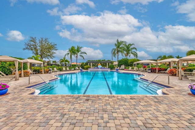 view of swimming pool with a patio and a gazebo