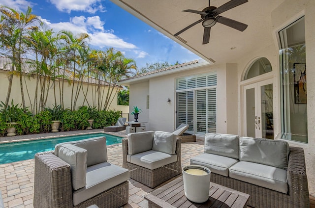 view of patio / terrace featuring ceiling fan, a fenced in pool, french doors, and an outdoor living space