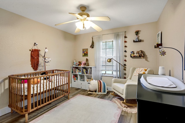 bedroom with a textured ceiling, hardwood / wood-style flooring, and ceiling fan