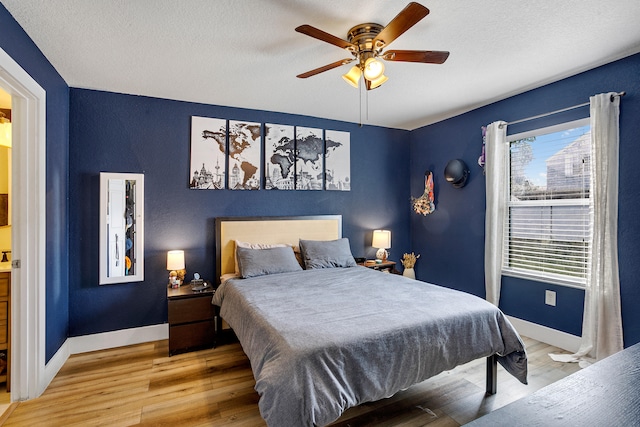 bedroom featuring a textured ceiling, ceiling fan, and light hardwood / wood-style flooring