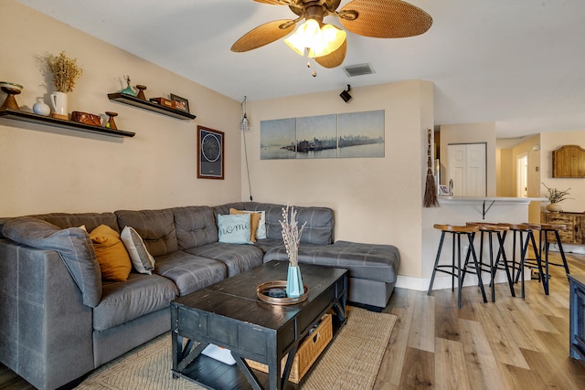 living room with hardwood / wood-style floors and ceiling fan