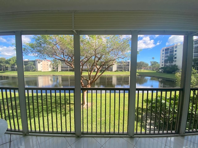 unfurnished sunroom featuring a water view