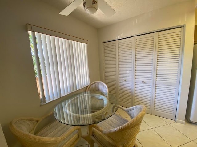 sitting room with light tile patterned floors, a textured ceiling, and ceiling fan