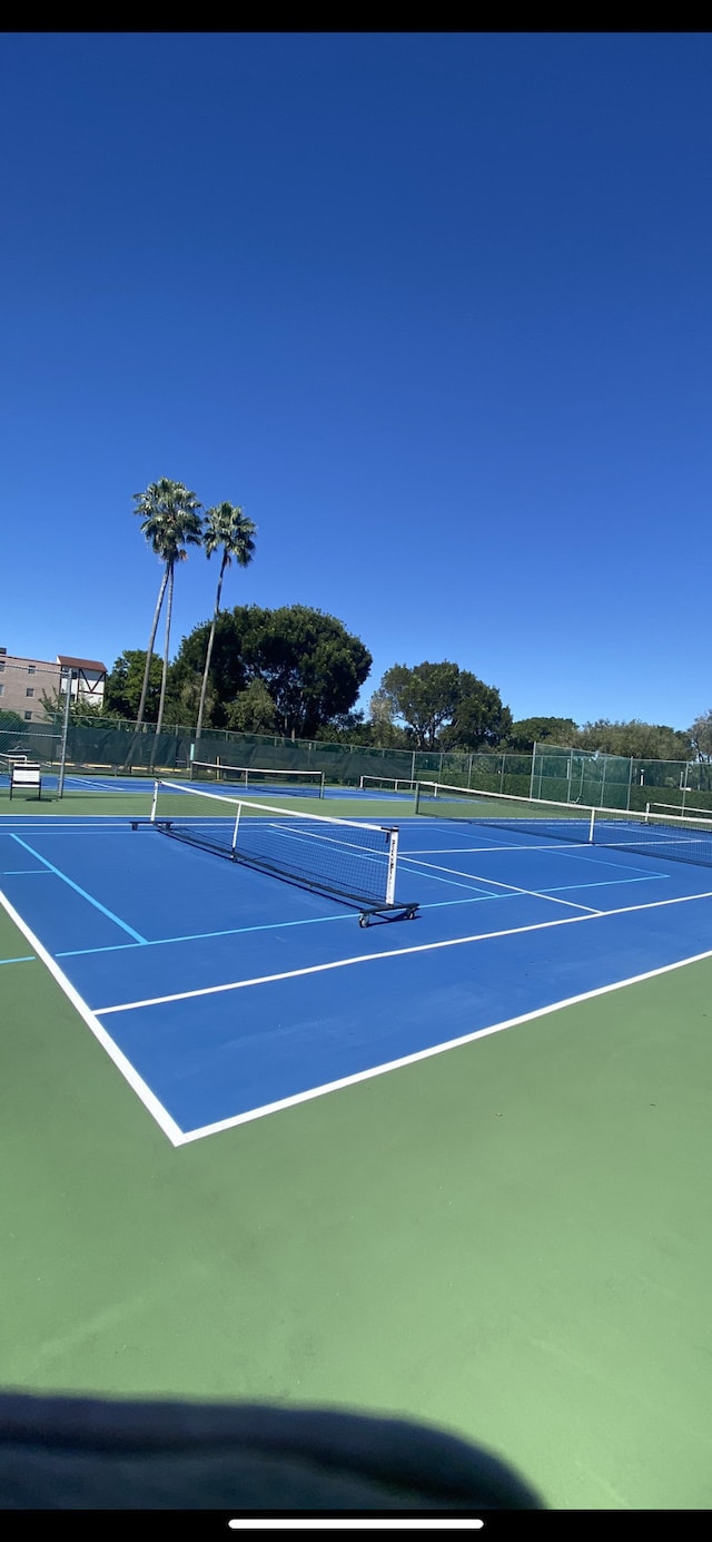 view of sport court with basketball hoop