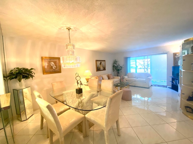 tiled dining area with a textured ceiling and a chandelier