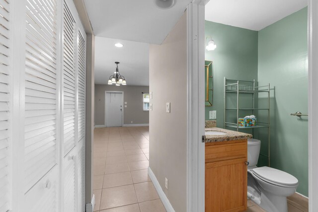 623 Monaco M, Delray Beach, FL 33446 - half bath with vanity, a closet, tile patterned floors, toilet, and baseboards