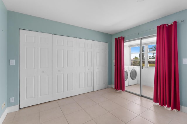 623 Monaco M, Delray Beach, FL 33446 - unfurnished bedroom with a closet, washing machine and clothes dryer, tile patterned flooring, and baseboards
