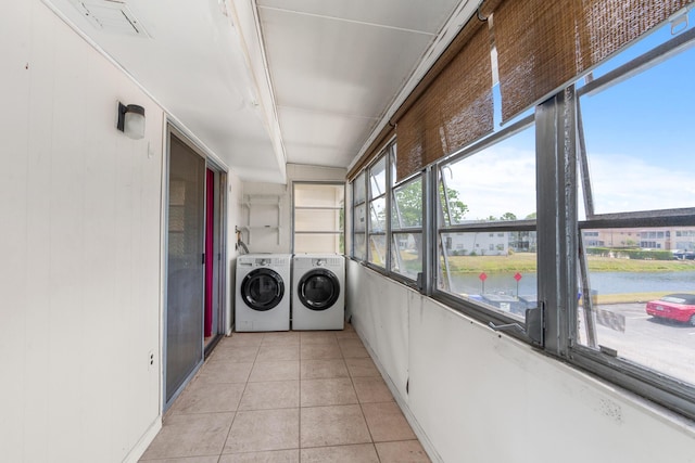623 Monaco M, Delray Beach, FL 33446 - washroom with light tile patterned floors, washing machine and dryer, a water view, and laundry area