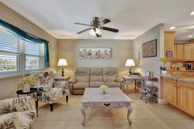 living room with ceiling fan and light tile patterned floors