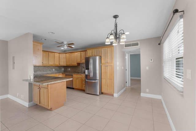 623 Monaco M, Delray Beach, FL 33446 - kitchen with appliances with stainless steel finishes, backsplash, a sink, visible vents, and a peninsula