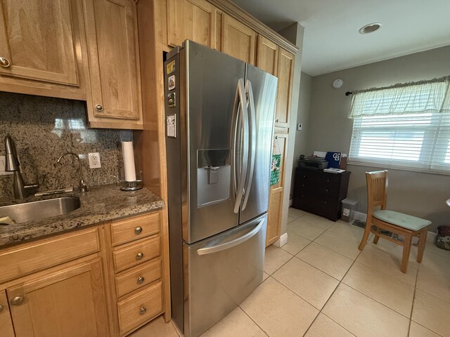 kitchen with backsplash, kitchen peninsula, white appliances, light brown cabinetry, and light tile patterned floors