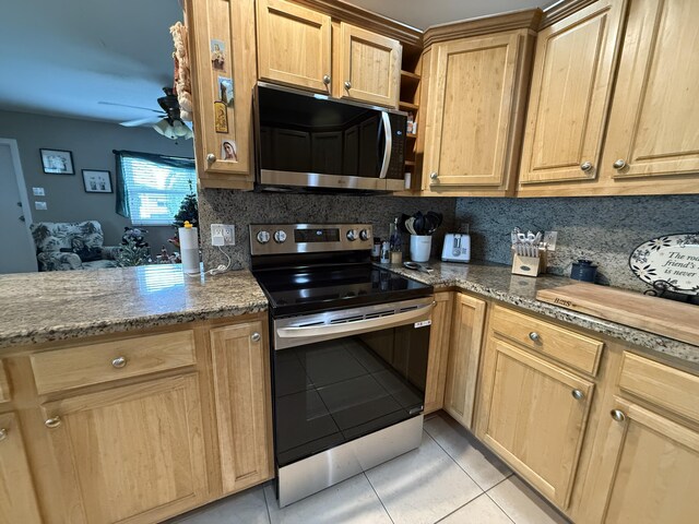 kitchen with stainless steel fridge, backsplash, sink, light tile patterned floors, and dark stone countertops