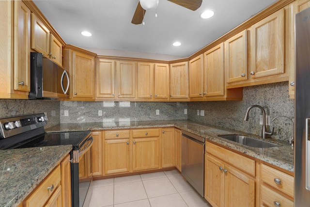 623 Monaco M, Delray Beach, FL 33446 - kitchen with decorative backsplash, light tile patterned floors, appliances with stainless steel finishes, a sink, and a ceiling fan