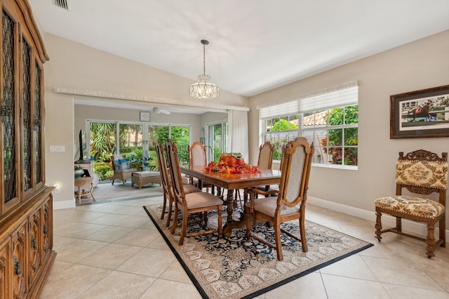 dining room featuring ceiling fan with notable chandelier, lofted ceiling, and light tile patterned floors