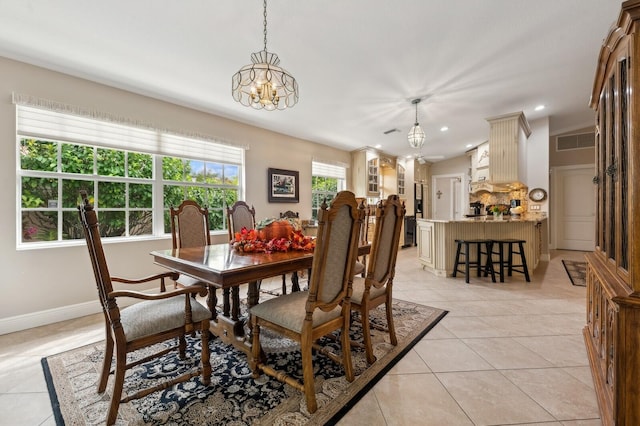 tiled dining area with a notable chandelier