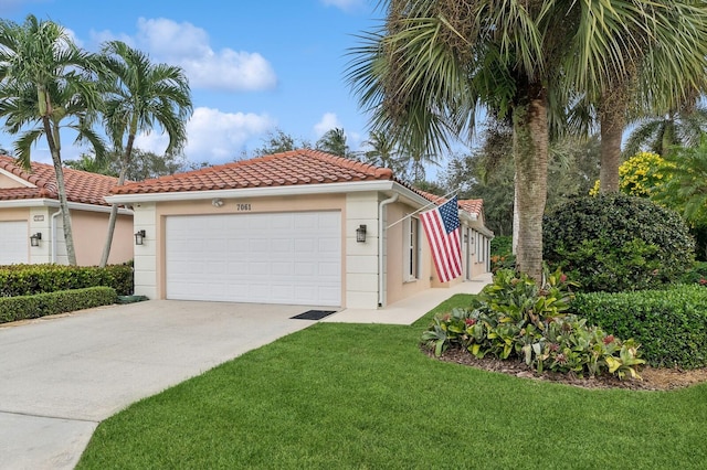 view of front of home featuring a front yard and a garage