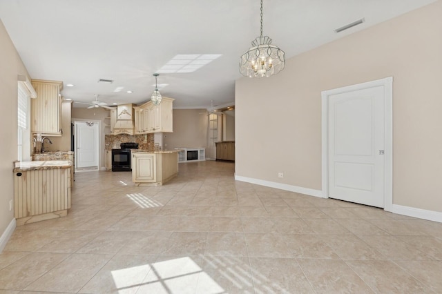 unfurnished living room featuring ceiling fan with notable chandelier, light tile patterned floors, and sink