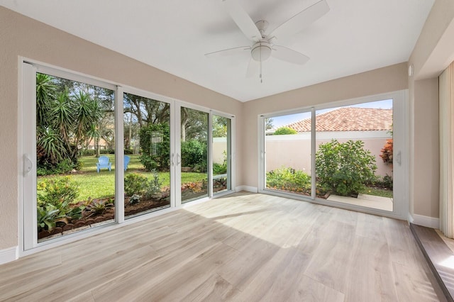 unfurnished sunroom with ceiling fan and a healthy amount of sunlight