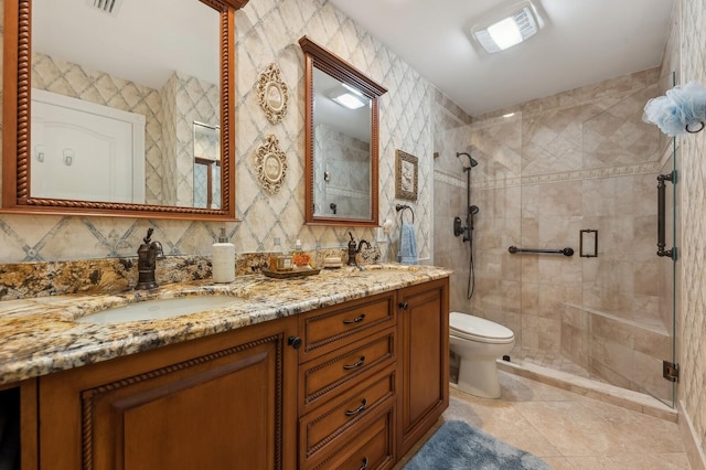 bathroom featuring tile patterned floors, backsplash, toilet, a shower with door, and vanity