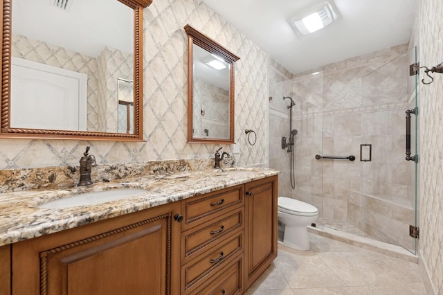 bathroom with toilet, vanity, tile patterned floors, and an enclosed shower