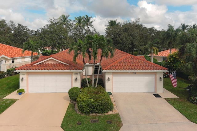 mediterranean / spanish-style house with a garage and a front lawn