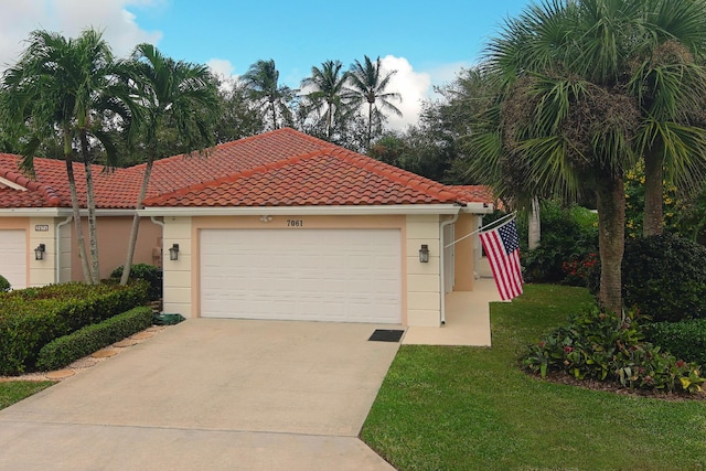 mediterranean / spanish home with a garage and a front lawn