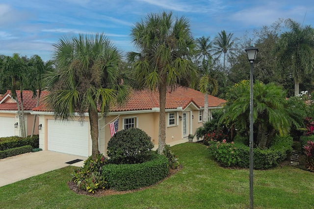 view of front of property with a front lawn and a garage