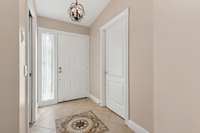 tiled entrance foyer with vaulted ceiling and an inviting chandelier