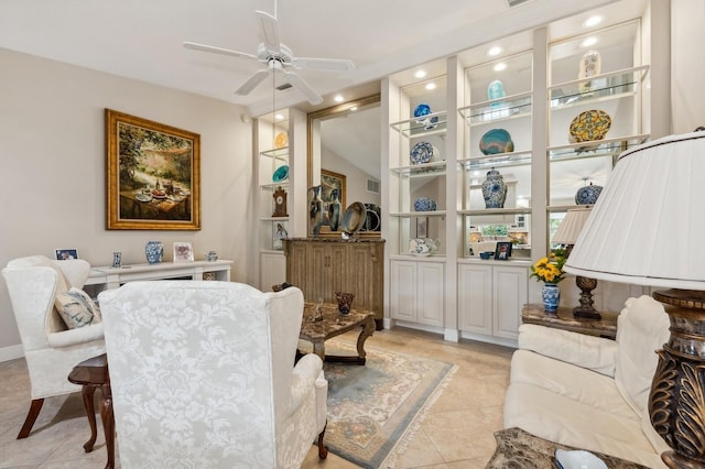 interior space with light tile patterned floors and ceiling fan