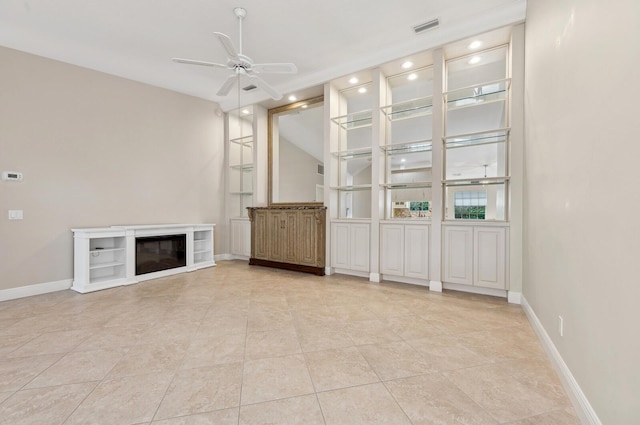 unfurnished living room with ceiling fan and light tile patterned flooring