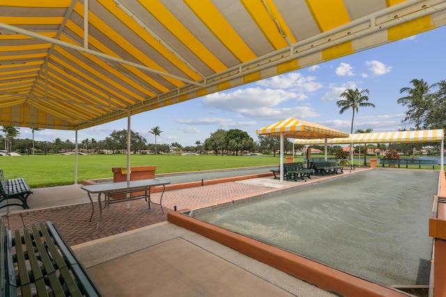 view of pool featuring a lawn