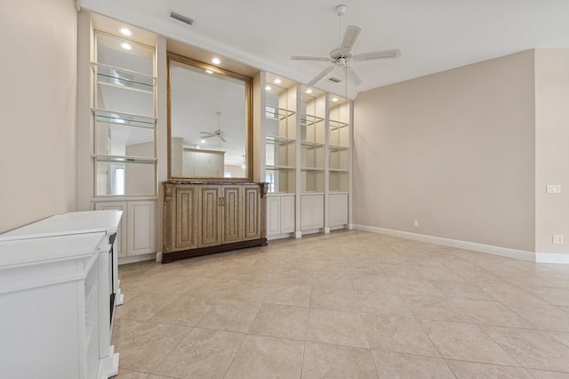 unfurnished dining area with ceiling fan and light tile patterned floors