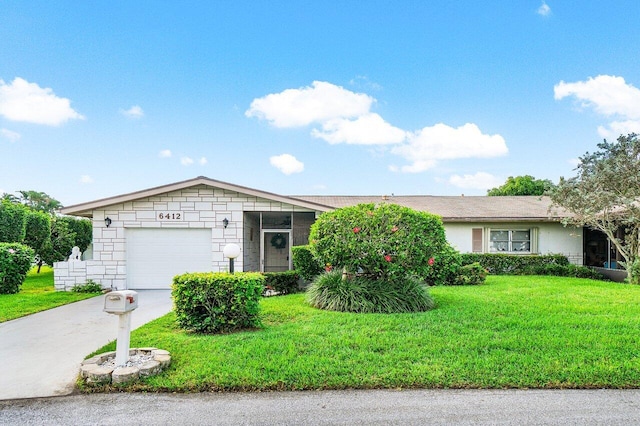 single story home with a garage and a front lawn